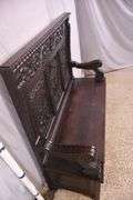 Carved oak bench with lift-top storage seat; 68-6821