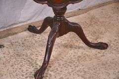 Carved mahogany tilt-top side table with ball in claw feet; 21-2749