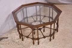 Mahogany octagonal glass top coffee table with cane-cut legs and stretchers; 68-6514
