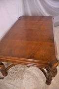 Carved walnut dining table with ornate trestle base; 74-12809D