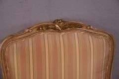 Pair of carved French style open armchairs with striped fabric; 68-6881