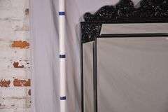 Large beveled mirror with black composite frame and beveled mirror trim; 1044-128