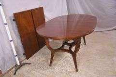 Oval mahogany dining table with 2 skirted leaves; 68-6585A