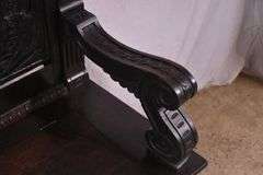 Carved oak bench with lift-top storage seat; 68-6821