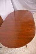 Oval mahogany dining table with 2 skirted leaves; 68-6585A