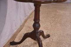 Carved mahogany tilt-top side table with ball in claw feet; 21-2749