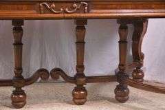 Carved walnut dining table with ornate trestle base; 74-12809D