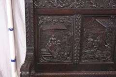 Carved oak bench with lift-top storage seat; 68-6821