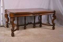 Carved walnut dining table with ornate trestle base; 74-12809D