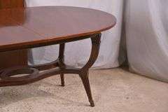 Oval mahogany dining table with 2 skirted leaves; 68-6585A