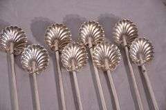 Set of 8 sterling silver shell-shaped sipper stirrers; 971-275