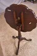 Carved mahogany tilt-top side table with ball in claw feet; 21-2749