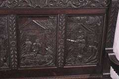 Carved oak bench with lift-top storage seat; 68-6821