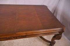 Carved walnut dining table with ornate trestle base; 74-12809D
