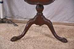 Carved mahogany tilt-top side table with ball in claw feet; 21-2749