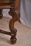 Carved walnut dining table with ornate trestle base; 74-12809D