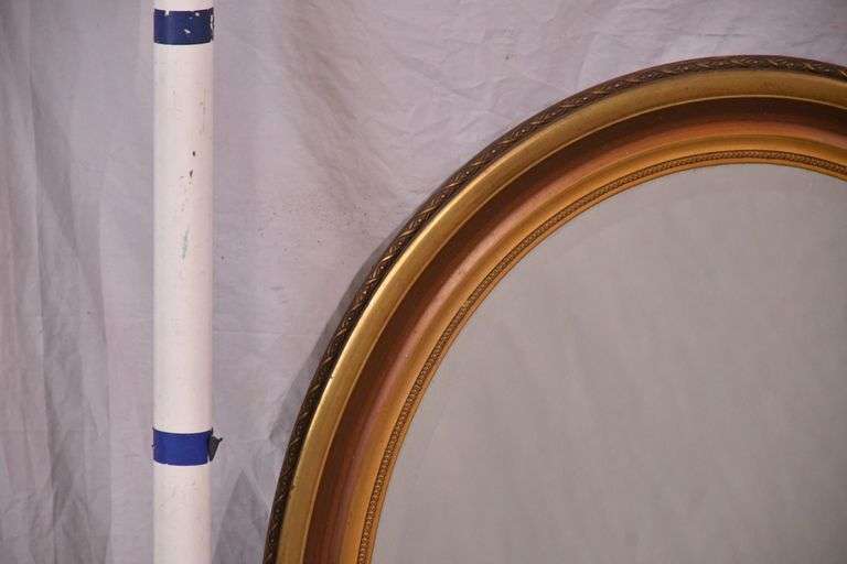 Oval beveled mirror with gold trimmed frame; 18305-001