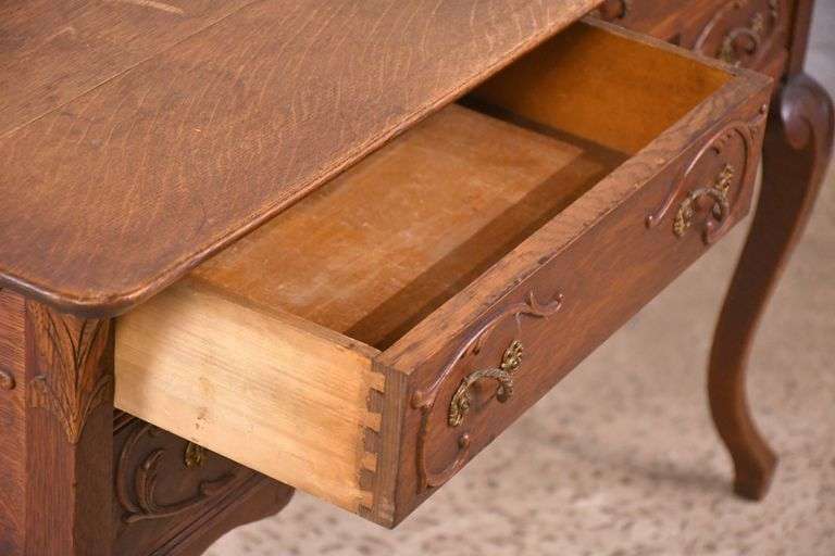 Carved oak 4 drawer writing desk; 55-12158