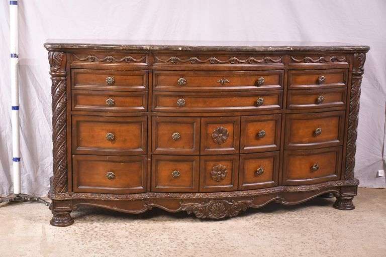 Ashley Furniture Co. large carved serpentine front 9 drawer triple dresser with marble tile top; 1153-098