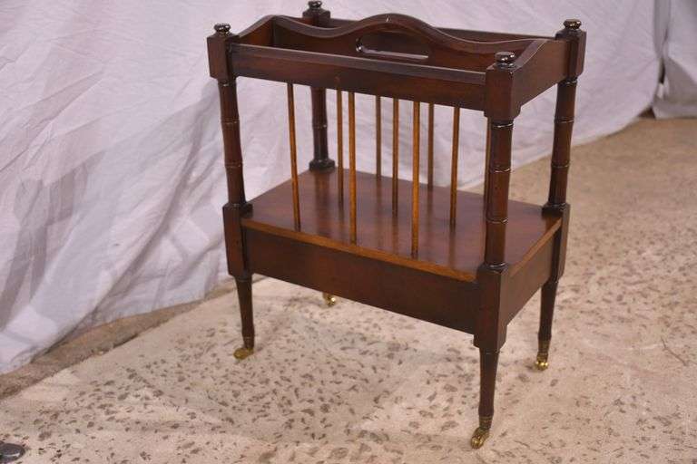 Mahogany single drawer canterbury with brass toe caps and casters; 396-1389