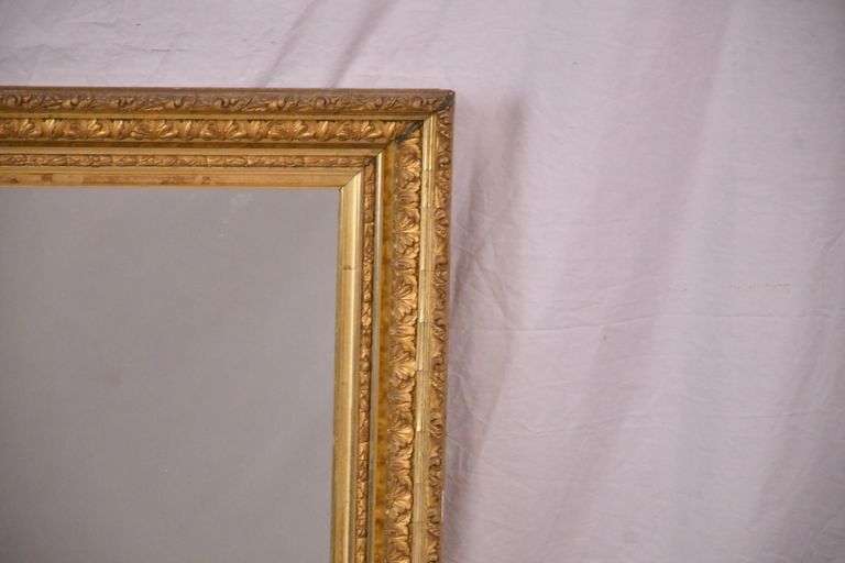 Early mirror with ornate gold frame; 1037-1166