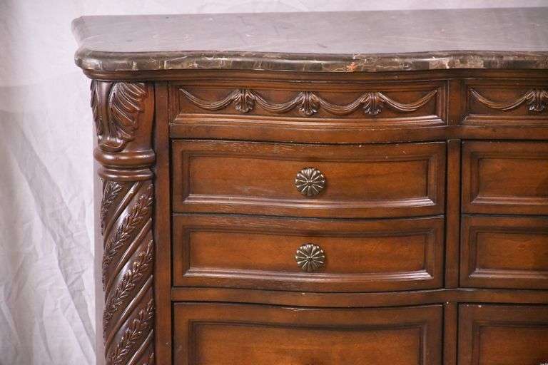 Ashley Furniture Co. large carved serpentine front 9 drawer triple dresser with marble tile top; 1153-098
