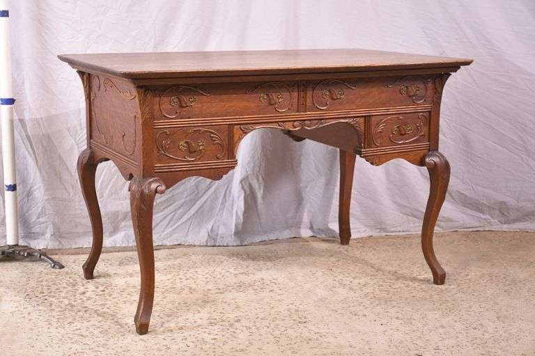 Carved oak 4 drawer writing desk; 55-12158