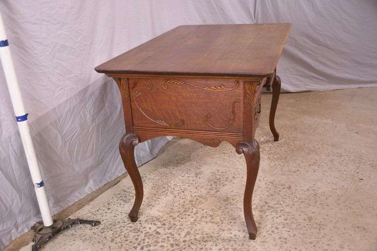 Carved oak 4 drawer writing desk; 55-12158