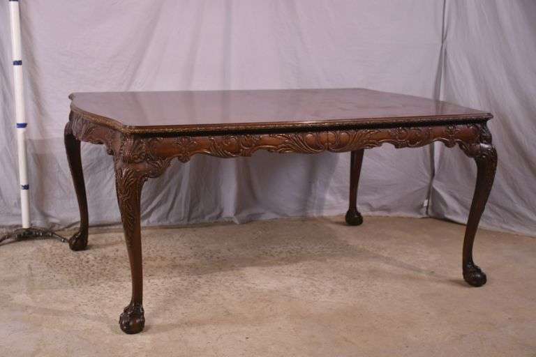 Carved mahogany dining table with ball in claw feet; 74-12884A