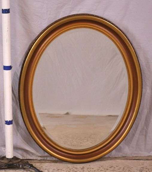 Oval beveled mirror with gold trimmed frame; 18305-001