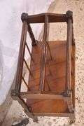 Mahogany single drawer canterbury with brass toe caps and casters; 396-1389