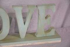 Carved wooden "Love" sign with marble base; 43-163