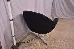 Mid-century style black upholstered tub chair with swivel chrome pedestal; 74-12883