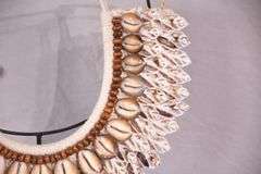 Puka shell necklace on stand; 16780-016