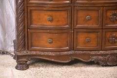 Ashley Furniture Co. large carved serpentine front 9 drawer triple dresser with marble tile top; 1153-098