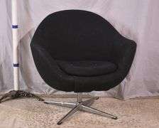 Mid-century style black upholstered tub chair with swivel chrome pedestal; 74-12883