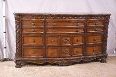 Ashley Furniture Co. large carved serpentine front 9 drawer triple dresser with marble tile top; 1153-098