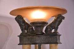 Large 3 column floor lamp with amber shade and lion figures on top; 74-12849