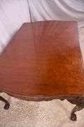 Carved mahogany dining table with ball in claw feet; 74-12884A