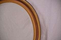 Oval beveled mirror with gold trimmed frame; 18305-001