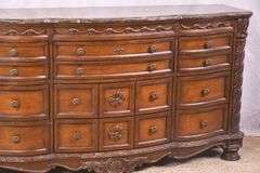 Ashley Furniture Co. large carved serpentine front 9 drawer triple dresser with marble tile top; 1153-098