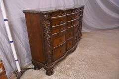 Ashley Furniture Co. large carved serpentine front 9 drawer triple dresser with marble tile top; 1153-098