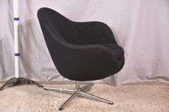 Mid-century style black upholstered tub chair with swivel chrome pedestal; 74-12883