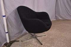 Mid-century style black upholstered tub chair with swivel chrome pedestal; 74-12883