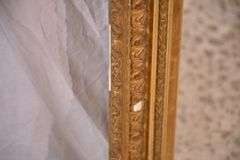 Early mirror with ornate gold frame; 1037-1166