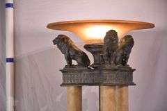 Large 3 column floor lamp with amber shade and lion figures on top; 74-12849