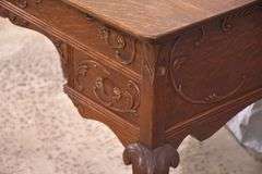 Carved oak 4 drawer writing desk; 55-12158