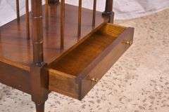 Mahogany single drawer canterbury with brass toe caps and casters; 396-1389