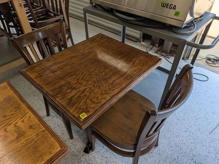 28"x24" wooden table with two chairs.