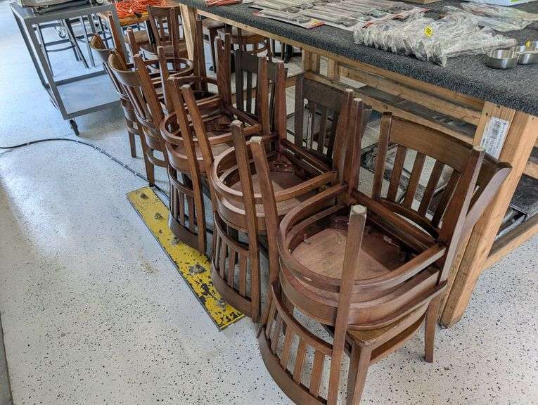 lot of ten wooden restaurant table chairs.